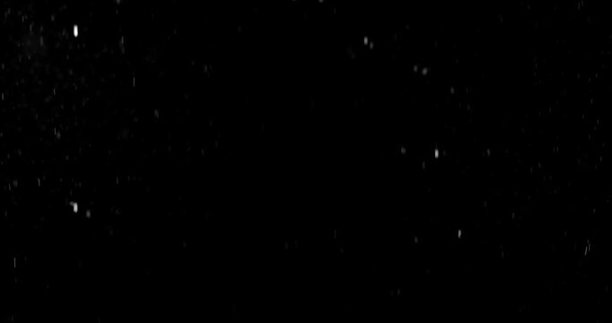 Slow motion floating water droplets on a black background. Premium VFX overlay for cinematic compositing, motion graphics, title animations, trailers and professional visual effects.
