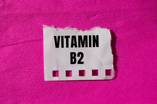 Vitamin B2 message written on ripped torn paper background. Conceptual Vitamin B2 symbol. Copy space.