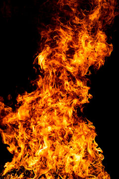 Blaze burns across black background. Blaze with fiery texture. Glowing blaze for poster overlay. Realistic blaze for design.