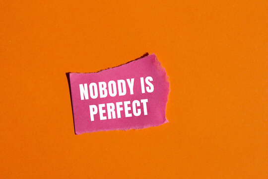 Nobody is Perfect message written on ripped torn paper background. Conceptual Nobody is Perfect symbol. Copy space.