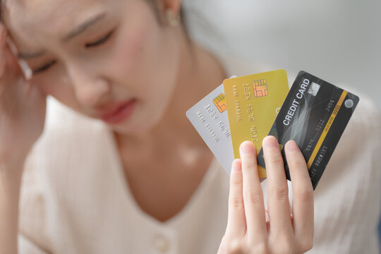Credit card debt concept. Stressed woman holding multiple credit cards, facing financial problems and debt management. Credit, debt, finance, budgeting, payment