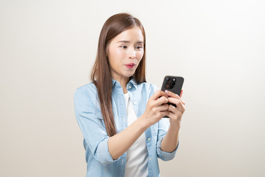 Happy asian young woman using mobile smart phone, read good news online, laugh excited getting offer, great positive surprise, celebrate success on smartphone. Smile girl isolated on white background.