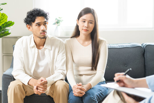 Psychology, depression asian young couple love woman and male patient consulting problem mental health with psychologist, psychiatrist at clinic together, wife encouraging husband, therapy health care