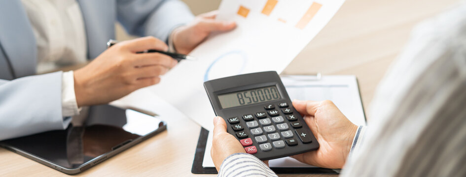 Business meeting, asian group brainstorm analysis on graph data of cost plan. financial consult planning investor asses and present to client, client and advisor review investment strategy in office.