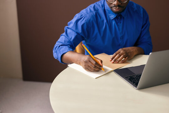 Man Writing Notes at Office
