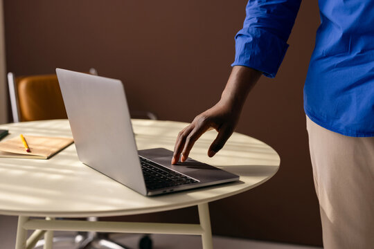 Person Using Laptop In Modern Office Workspace