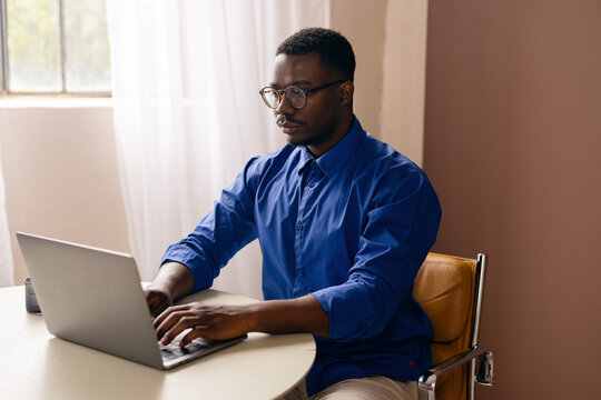 Man Working On Laptop At Home Office