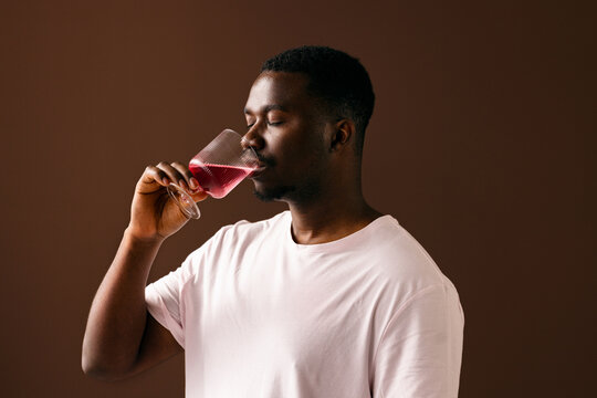 Man Savoring Red Wine In Calm Portrait