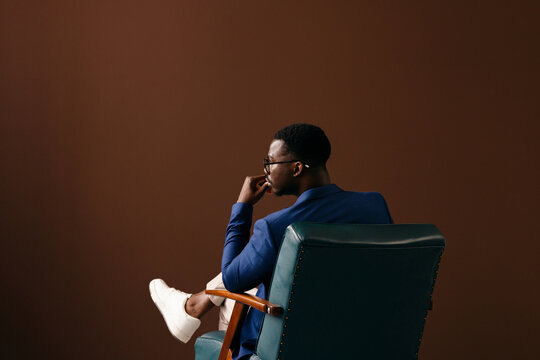 Thoughtful Businessman Sitting in Chair, Business Portrait