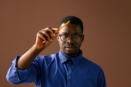 Thoughtful Man With Glasses Holding Pencil 