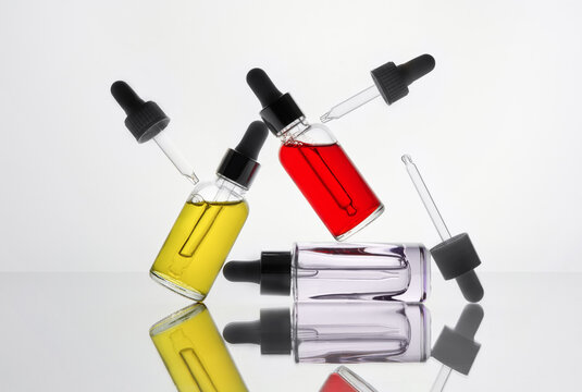Dropper Bottles and Perfume Bottles in Abstract Laboratory Composition