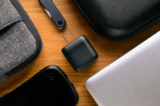 USB Charger with Gadgets on Wooden Table