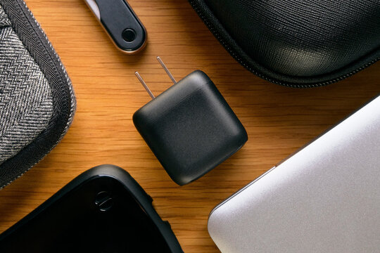 USB Charger with Gadgets on Wooden Table
