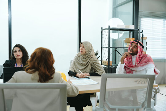 Business teamwork meeting in a modern office where diverse professionals review reports and discuss strategy, collaboration, leadership, planning, productivity, corporate analysis and growth.