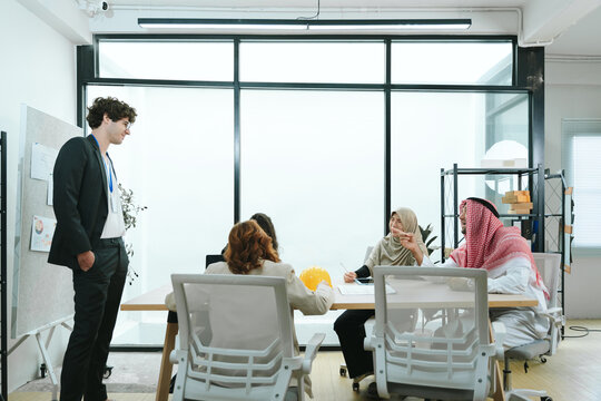 Business teamwork meeting in a modern office where diverse professionals review reports and discuss strategy, collaboration, leadership, planning, productivity, corporate analysis and growth.