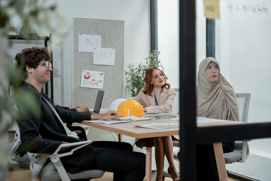 Business teamwork meeting in a modern office where diverse professionals review reports and discuss strategy, collaboration, leadership, planning, productivity, corporate analysis and growth.