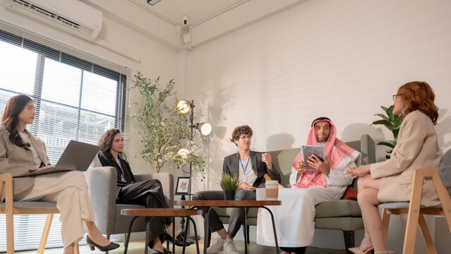 Business teamwork meeting in a modern office where diverse professionals review reports and discuss strategy, collaboration, leadership, planning, productivity, corporate analysis and growth.
