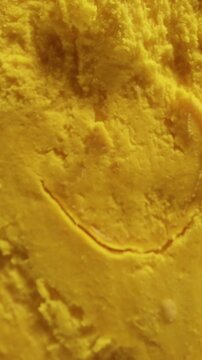Dolly Slider Close Up of a Halved Ripe Canistel Fruit with Glossy Brown Seeds And Dense Golden Flesh Isolated against a Black Background Vertical video.