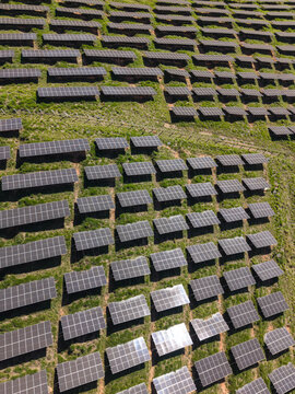 Aerial view of a solar energy farm on a mountain