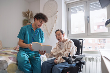 Plakat Caregiver reading inspiring book to woman in wheelchair