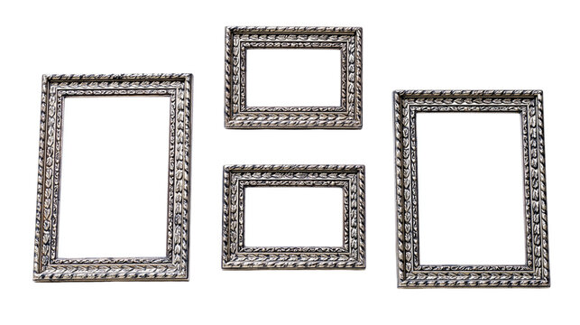 Three ornate antique silver picture frames with intricate leaf pattern borders