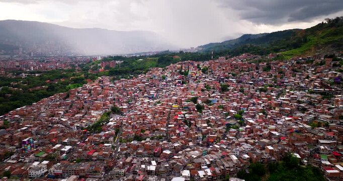 Dense hillside houses in Comuna 13 neighborhood in Medellin, Colombia. Aerial forward