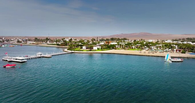 Aerial view of jetty and leisure craft on Paracas coastal town waterfront