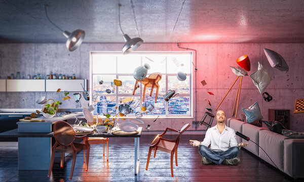 Man meditating levitating objects in surreal interior scene