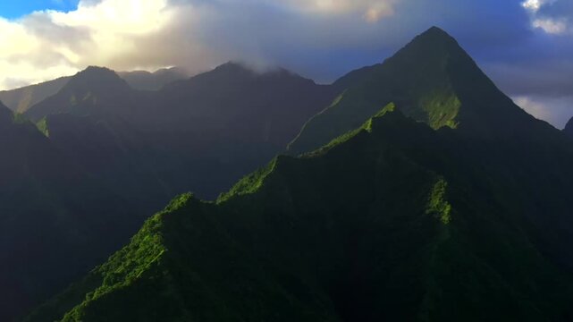 Towering mountains peaks of Teahupo'o Tahiti Ito Volcano ridges South Pacific Island French Polynesia aerial drone sunset clouds Tara Huhurahi Mount Ronui Aorai Orohena Vaiau River Valley zoom in