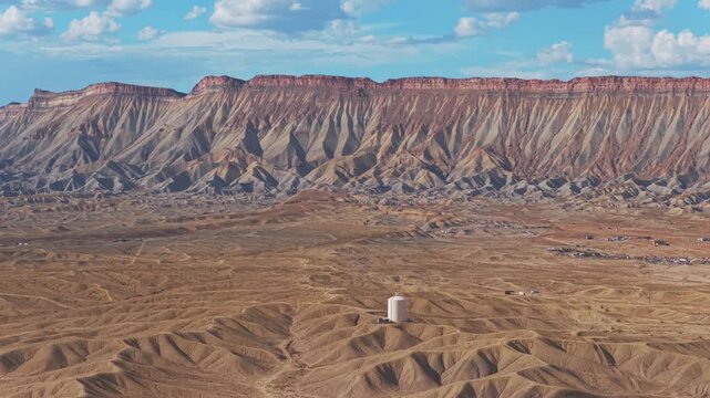 Aerial drone view of cars i70 Book Cliffs Mesa Clifton Downtown Grand Junction tower Colorado afternoon clouds summer sunny blue sky desert Grand Mesa chutes Parachute Fruita Mt Garfield circle