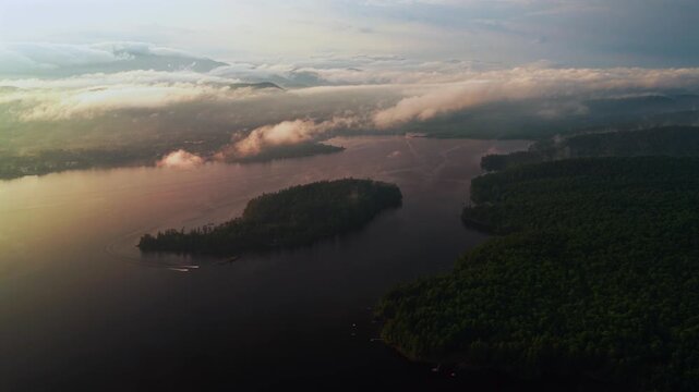 Jet Skis Lake Schroon Clarks Island ummer golden hour sunset mist low clouds aerial drone harbor view Up State New York landscape Town of Schroon Lake Pharaoh Mtn Adirondack Mountains circle left