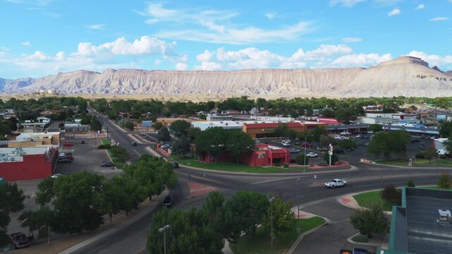 Downtown Grand Junction Book Cliffs Mesa Clifton aerial drone Colorado afternoon cloudy Grand Mesa Colorado River summer sunny blue sky Parachute Fruita Mt Garfield businesses cars i70 upwards motion