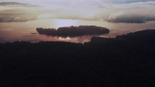 Boat ride Lake Schroon Clarks Island ummer golden hour sunset mist low clouds aerial drone harbor view Up State New York landscape Town of Schroon Lake Pharaoh Mtn Adirondack Mountains forward pan