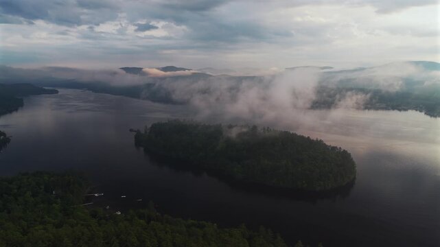 Sunset Lake Schroon Clarks Island aerial drone summer golden hour mist low clouds harbor view Up State New York landscape Town of Schroon Lake docks Pharaoh Mtn Adirondack Mountains circle left motion