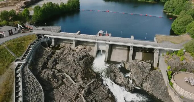 Aerial view of Rykene dam and hydroelectric power station in slow motion