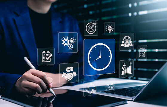 Time management and business productivity concept. Businesswoman using laptop with workflow icons for scheduling, goals, planning, efficiency, project management, corporate strategy, task tracking