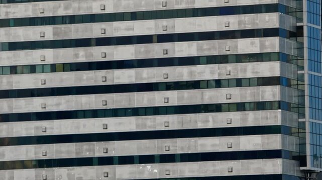 Timelapse of diverse building facades and architectural structures forming repeating urban patterns, capturing geometric lines, shapes, textures, and changing light.