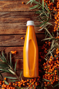 Bottle of sea buckthorn juice with fresh berries.