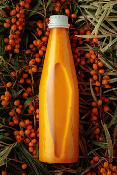 Bottle of sea buckthorn juice with fresh berries.