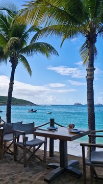 Vertical View of Beachfront Restaurant Table and Caribbean Sea on St. Barthelemy Island