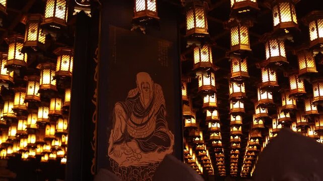 Glowing paper lanterns illuminating the night during the traditional Kangen Sai Festival events on Miyajima Island, Hiroshima, Japan