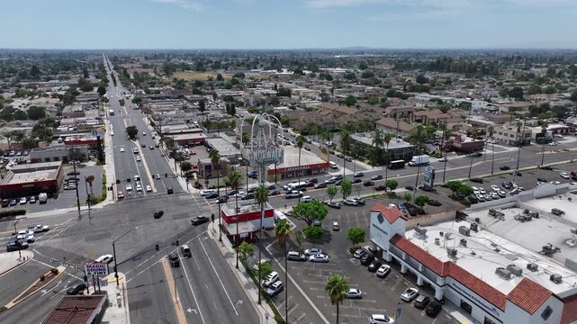 Norwalk, California, USA: Wide Drone View of Downtown Urban Neighborhood With Famous Norwalk Sign Near Pioneer Boulevard and Firestone Boulevard During Daytime