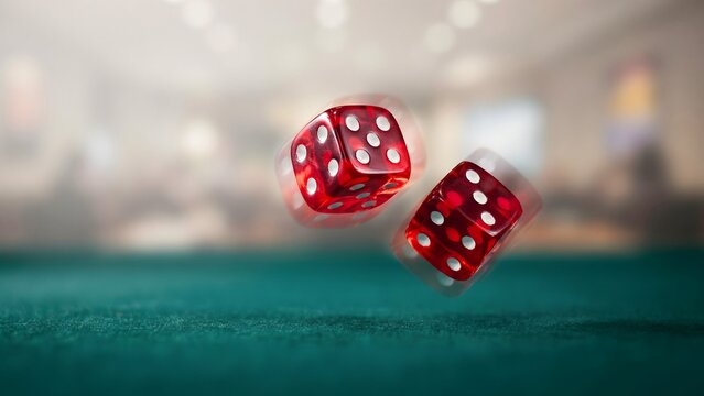 Close-up of two red game dice rolling above a gaming table surface with blurred gaming room background