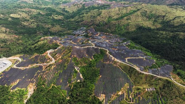 Aerial solar grid over green hills reflects resilience and energy autonomy
