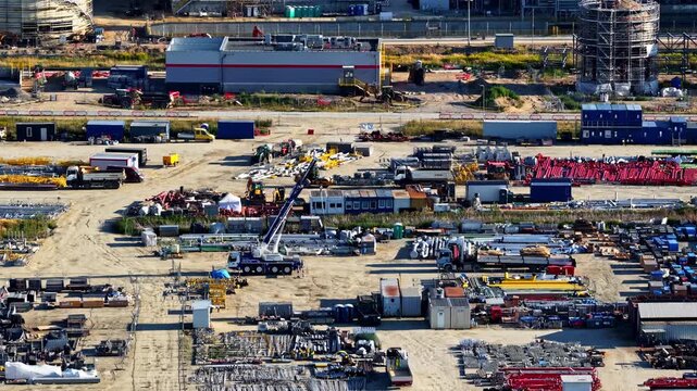 Construction developing site of oil petrofuel production plant industrial equipment and construction area in Poland, aerial tracking left