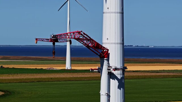 Self-climbing crane dismantling wind turbine tower at Eemshaven, Netherlands