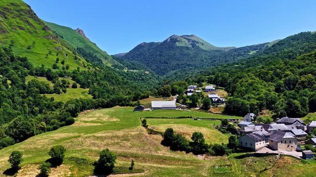 Drone flying over Col d'Aubisque valley and traditional village in French Pyrenees