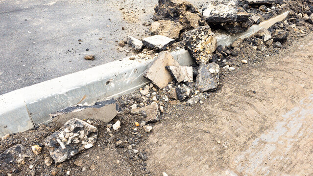 Broken asphalt and pavement debris removed during road reconstruction, showing demolition of old infrastructure before installation of a renewed urban surface