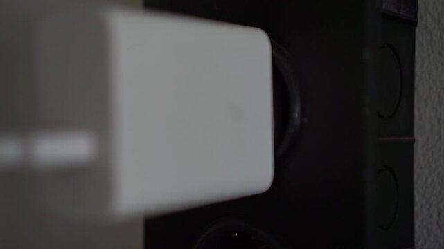 Hand take out charger from to wall socket, electrical power connection, technology concept footage scene.