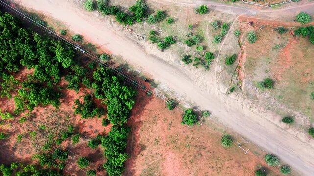 The land and roads of Hoa Thang in Lam Dong show a mix of green trees and bare soil. Aerial views capture the layout and patterns of this rural area. Nature and roads intersect in this setting.